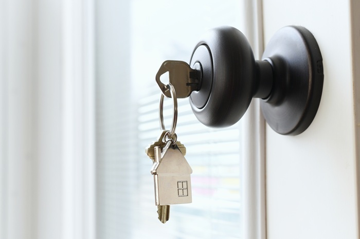 House key in a front door lock representing residential leases and landlord-tenant rights