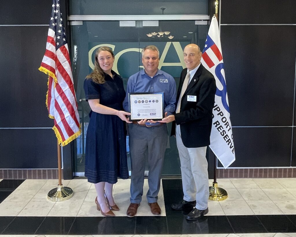 Lt. Col. Courtney Buechler, Craig Sharnetzka and Col. James Astor of ESGR holding the Seven Seals Award at CGA Law Firm in York, PA.